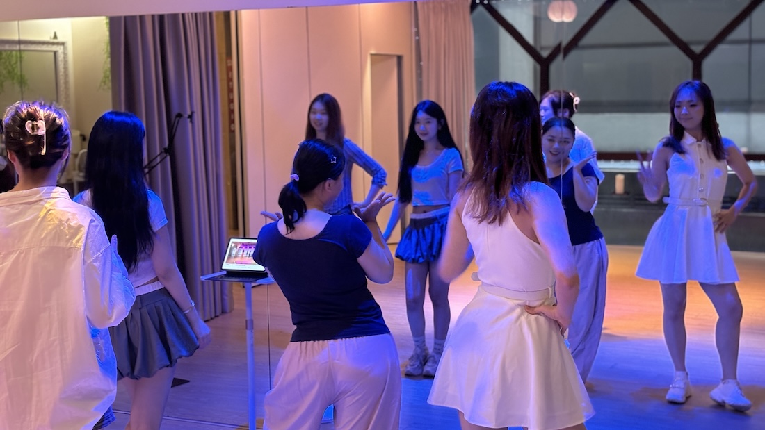 A group dance class in progress with an instructor