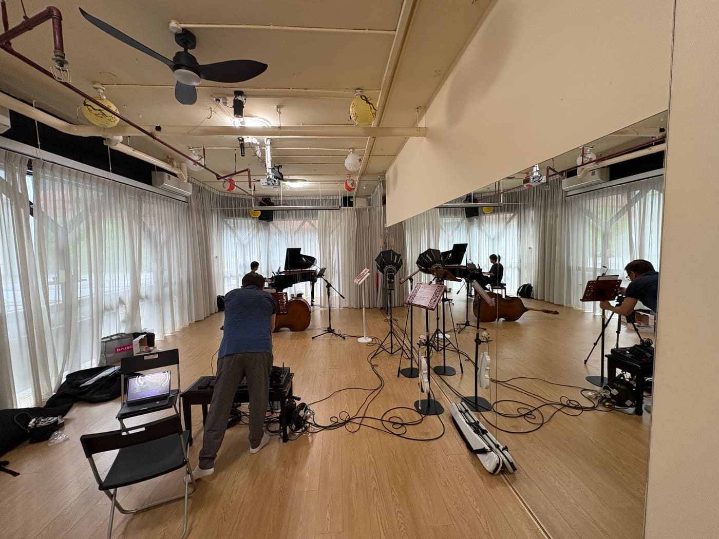A crew filming in the studio with lights and a camera rig