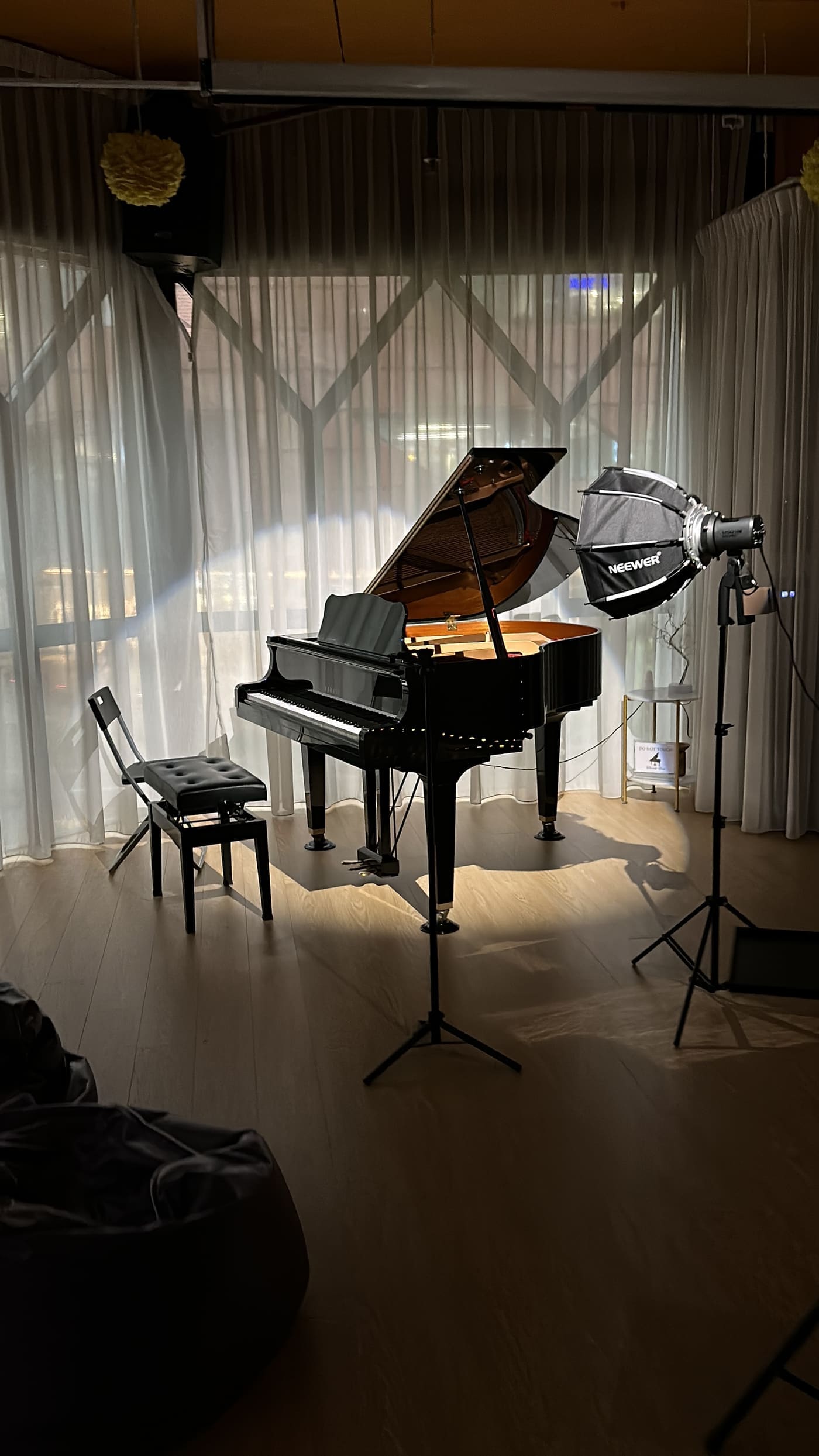 A softbox lighting the grand piano for a shoot