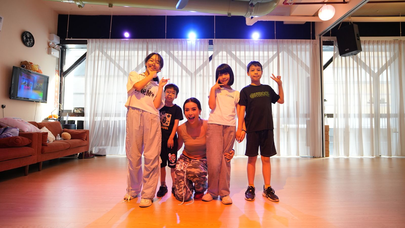 A teacher and four kids striking a pose after class in the Party Studio
