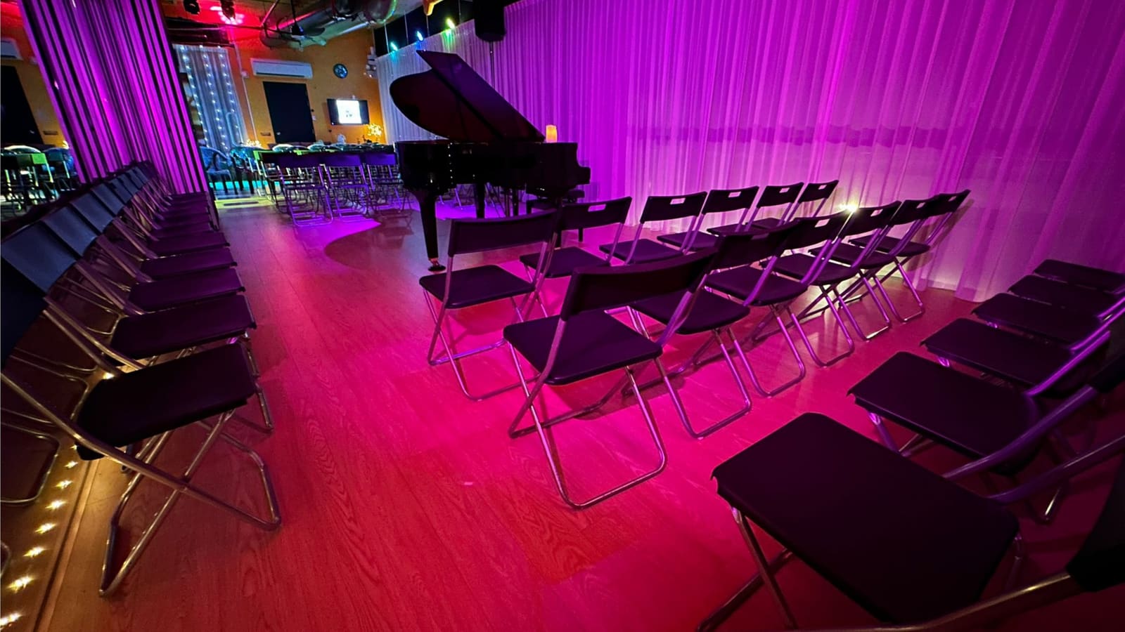 The Grand Studio set for a recital — rows of seating facing the grand piano under stage lighting